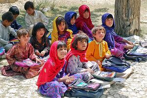 Gardez şehri yakınında bulunan Bamozai ilköğretim okulunun kız sınıfında oturan kız çocukları. Okulun binası yoktur ve dersler açık havada bostanın gölgesinde yapılmaktadır.